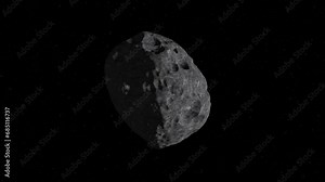 Asteroid in outer space. Asteroid or meteorite gyrating on starry space background. The lone asteroid slowly rotates on space background. 4K video.