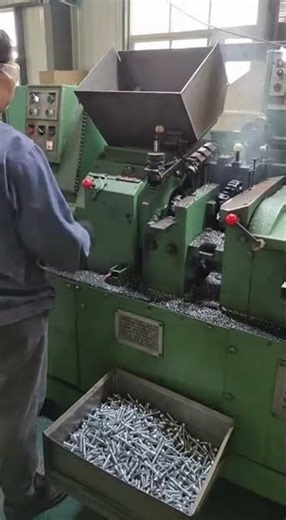 Woman Operating Machinery to Produce Metal Screws