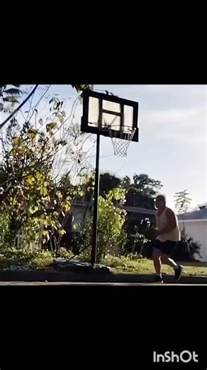 60 year old mimicking Larry Bird reverse dunk.