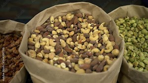 Mix of nuts. Organic nuts in paper packaging. Peanuts, hazelnuts, almonds, cashews, pine nuts, pistachios. Vegan shop. Sports nutrition. Diet. Healthy food.