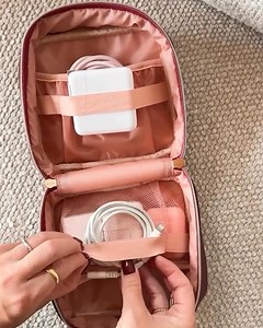 Say goodbye to lost chargers and tangled cords. This compact cube has everything you need to stay organized on the go. The Teched Out features a slide pocket, mesh pouch, and sturdy elastic straps to safely stow chargers, cords, earbuds, and more. Get 15% off your first order today with code: HELLO15 | Poppy & Peonies