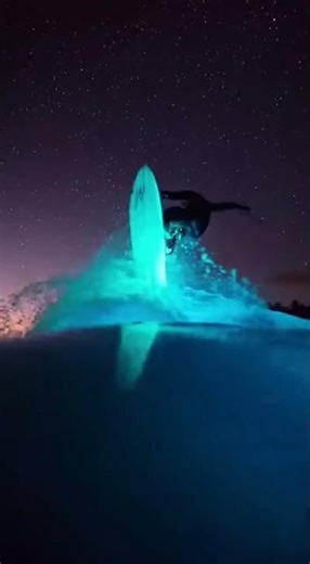 Surfer Rides a Glowing Wave Under the Stars 🌌💙