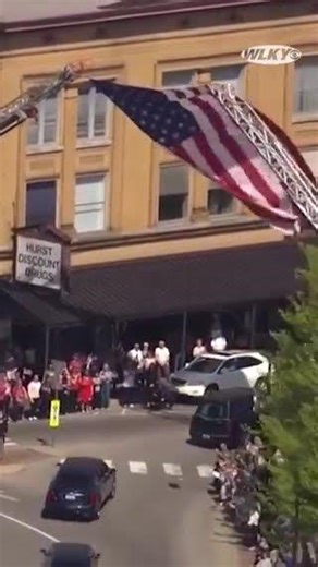 Hearse carrying Sgt. Pruitt moves through Bardstown under giant flag