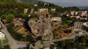 Përmet is a small town and municipality in Gjirokastër County, southern Albania. Aerial video of the big stones (guri i qytetit rock) on a sunny day. High angle view of the old town district.