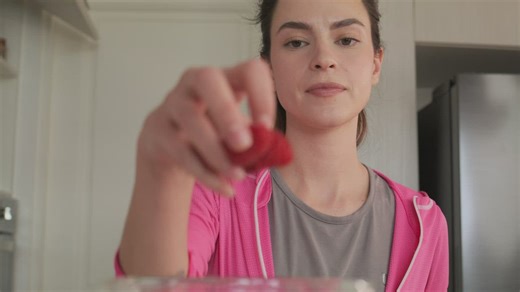 Woman preparing a smoothie with fruit and milk - Free Stock Video