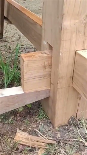 A large wooden stick that is being neatly arranged by a craftsman