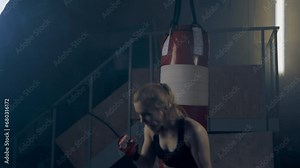 Woman boxer boxing with shadows in a semi-dark room, practicing punches, shadow boxing, slow motion. Video for motivation, goal achievement, success Stock Video
