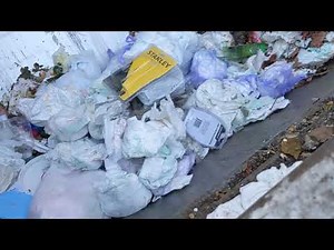 bin filled with dirty diapers get squished in garbage truck