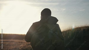 Tourists with backpacks at sunset travel through the mountains. The concept of a healthy lifestyle. Stock Video
