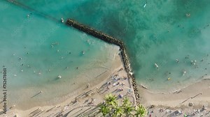 Top down view Paradise island nature background. Copy space wallpaper of summer vacation on tropical Hawaii. People swimming in blue water and sunbathing in golden sun 4K over beautiful Waikiki beach