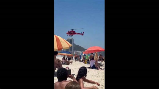 Emergency helicopter hovers over Copacabana Beach after plane crash, Brazil