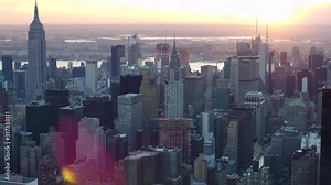 Aerial view of Manhattan skyline and cityscape. Iconic skyscrapers. Sunset in New York City, United States. Shot from a helicopter.