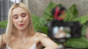 Two beautiful content creator making natural beauty and cosmetic tutorial on green plant leave garden video. Beauty blogger showing how to apply beauty care to social medial audience. Blithe