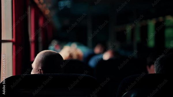 People sitting in a moving train with sunlight peaking through the windows