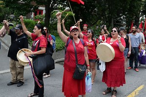 As part of a national day of action called UNsettling Canada 150, Indigenous activists and allies marched upon Carolyn Bennett's Canada Day picnic in Toronto to raise awareness on issues afflicting their communities. | Maclean’s