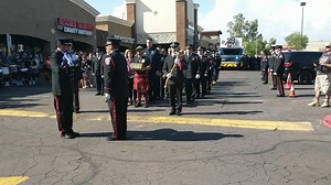 Family members of late Goodyear firefighter Austin Peck walk off after a flag-folding ceremony