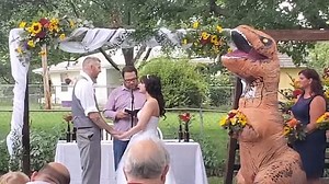 Woman dresses as a T-rex at her sister's wedding