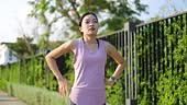 Young healthy woman exercising outdoors by running, She is warming up...