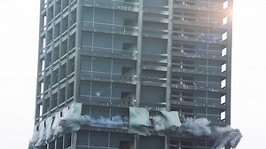 Skyscraper demolition blast. Building collapsing in real time.