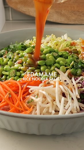 This Edamame Rice Noodle Salad is veggie (and protein) packed. Made with rice noodles and served with a sweet chili lime dressing! | This Savory Vegan
