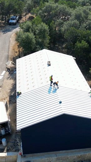 Installing 24 gauge standing seam metal for a client of ours near San Antonio! | First Out Roofing