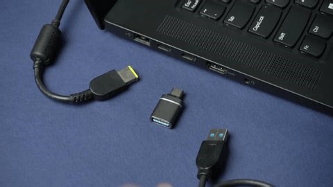 clip-4009666711-hand-reaches-connect-usb-c-cable-laptop-port