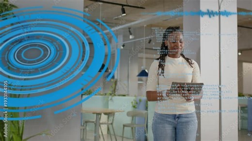 Female tech worker tapping tablet, initiating blue rings and code overlay, reviewing code in office