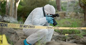 Forensic, photographer and police tape at crime scene for investigation in forest with evidence and safety hazmat..Csi quarantine, expert investigator and pictures for observation and case research
