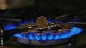 gas stove burner with russian ruble coins on top, burning gas