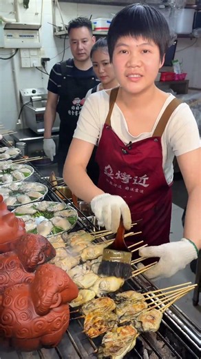 Massive charcoal-grilled oysters! Charred at edges, tender inside, one bite and you're hooked.