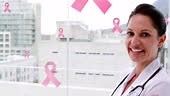 Animation of pink ribbon cancer logos floating over smiling female...
