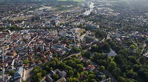 A wide aerial view around the old town of the city Oldenburg in Germany on a sunny summer morning