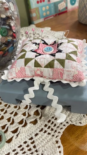 Debbie Martinez on Instagram: "I made this pincushion using ten sisters easy piecing grids. The finished block size is 1/2 inch. And Kelly made the wooden base. And the Rick rack finished it off! #pincushions #tensisterseasypiecinggrid #vintagetrim #besthusbandever❤️"
