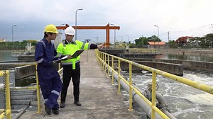 Environmental engineer working at wastewater treatment plant, analyzing water quality, monitoring pollution control, and ensuring sustainable management for industrial environmental protection.