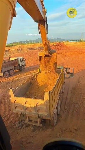 Excavators Load Soil Onto Trucks