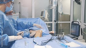 A team of surgeons during an operation to remove veins - phlebectomy. Surgical operation in the clinic Stock Video