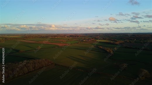 Golden hour sunset light glows over yorkshire farming land and fields in North Yorkshire outside Harrogate Spa Town