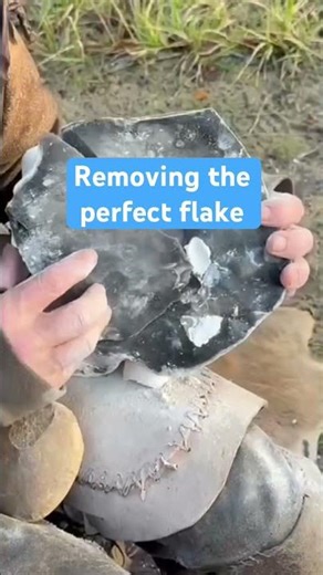 Spalling a large piece of flint with a hammer stone - reading the angles, trusting the strike.