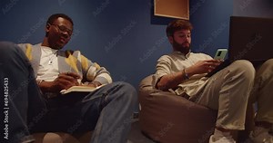 Business teammates collaborate confidently in a co-working space, driving profit growth. Diverse employees solve problems, gather data, and work together on tasks for a successful small company.