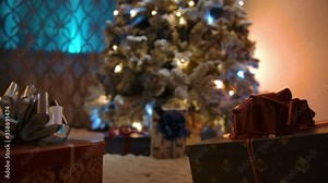 Dolly tracking shot from Christmas present to Christmas tree top. Bottom view. New Year's Eve Gift expectation concept.