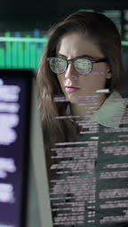 Stock video clip of a young woman working in a dark research...