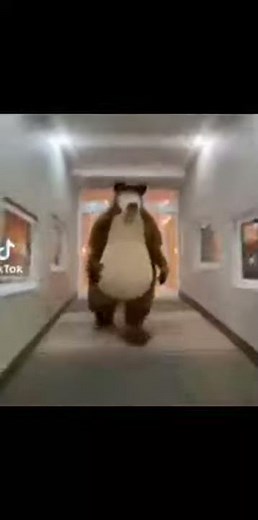 bear costume running down hallway
