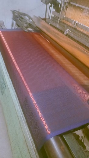 Textile Manufacturing Process: Weaving Machine in Action