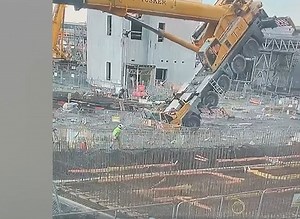 Watch: Building workers jump for safety as crane tips over on construction site
