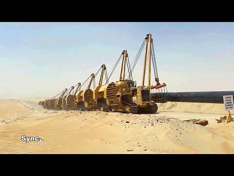 Caterpillar Pipelayer machines at work - Sidebooms pipe lowering using cradles