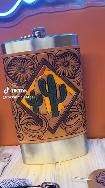 64oz flask wrapped in hand tooled and hand painted leather by Yours Truly🤠 This flask is available for purchase in the shop and on the website. Stay warm during calving or go paint the town!🥃 #flask #flaskwrap #westernflask #leatherwork #rockinmcleather