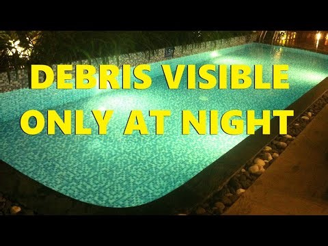 Floating Particles In Pool At Night With Light On
