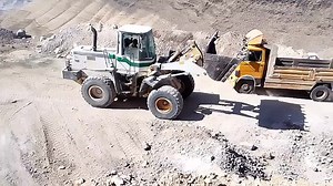 Front Loader and Dump Truck in Action at Construction Site