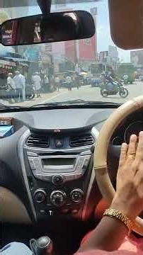 After getting a license, I learn to drive a car on a busy road.