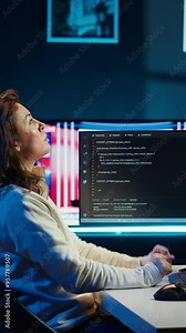 Vertical video Cybersecurity expert using computer and augmented reality to look for company security vulnerabilities and injected malware. Programmer installing code on PC, looking at AR